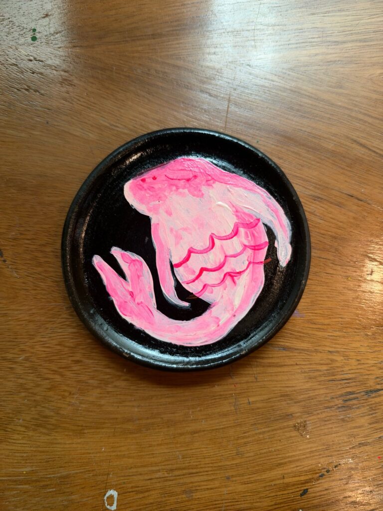 Pez pintado en acrílico rosa magenta sobre plato de barro negro oaxaqueño